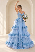 Light blue 3D floral tulle prom dress featuring a sweetheart neckline, sheer corset bodice, spaghetti straps, and a dramatic tiered floor-length A-line skirt.