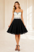 Black and white strapless homecoming Dress with pearl beaded bodice and A line skirt front view