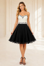Black and white strapless homecoming Dress with pearl beaded bodice and A line skirt front view