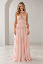 Blush pink beaded chiffon A-line wedding guest dress with V neckline, spaghetti straps, floral lace bodice, draped scarf detail and floor length skirt by Graceprom