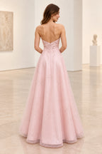 Back view of blush pink satin and tulle prom dress featuring V-shaped strapless back, floral beadwork, fitted waist and flowing A-line skirt