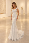 Ivory beaded tulle mermaid wedding dress with square neckline, embellished wide straps, fitted corset-inspired bodice and sweeping bridal train by Graceprom