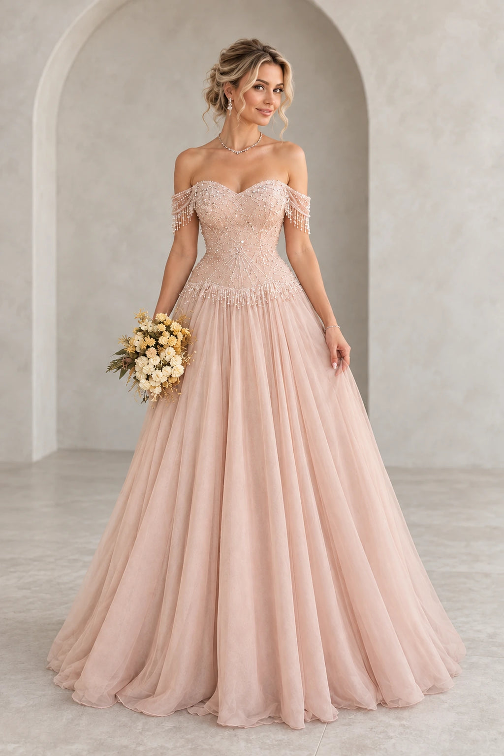 Graceprom blush tulle A-line prom dress with a beaded sweetheart bodice, off shoulder fringe sleeves and a full floor length skirt.