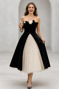 Black and ivory strapless A-line tea length wedding guest dress with bow detail by GraceProm