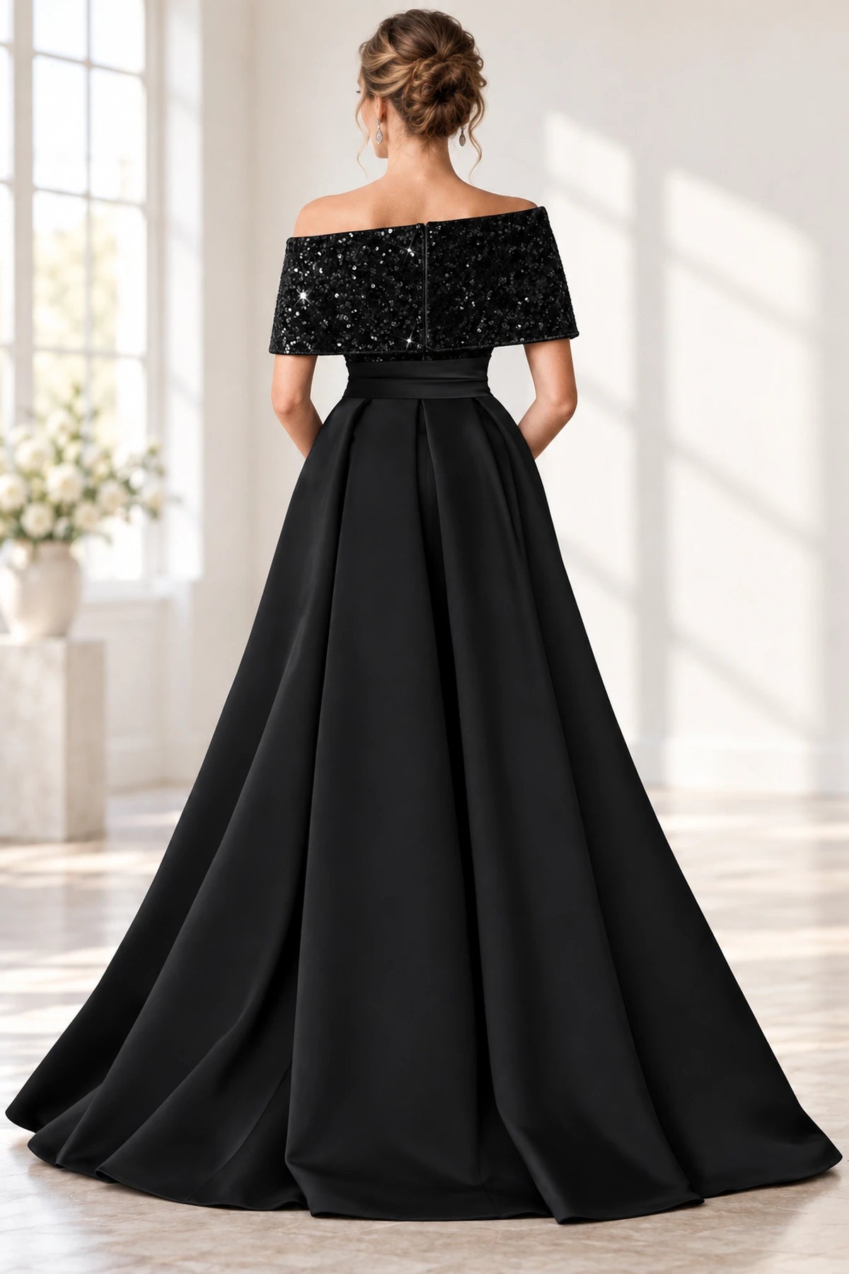 Back view of black mother of the bride dress with off shoulder sequin overlay and full satin skirt