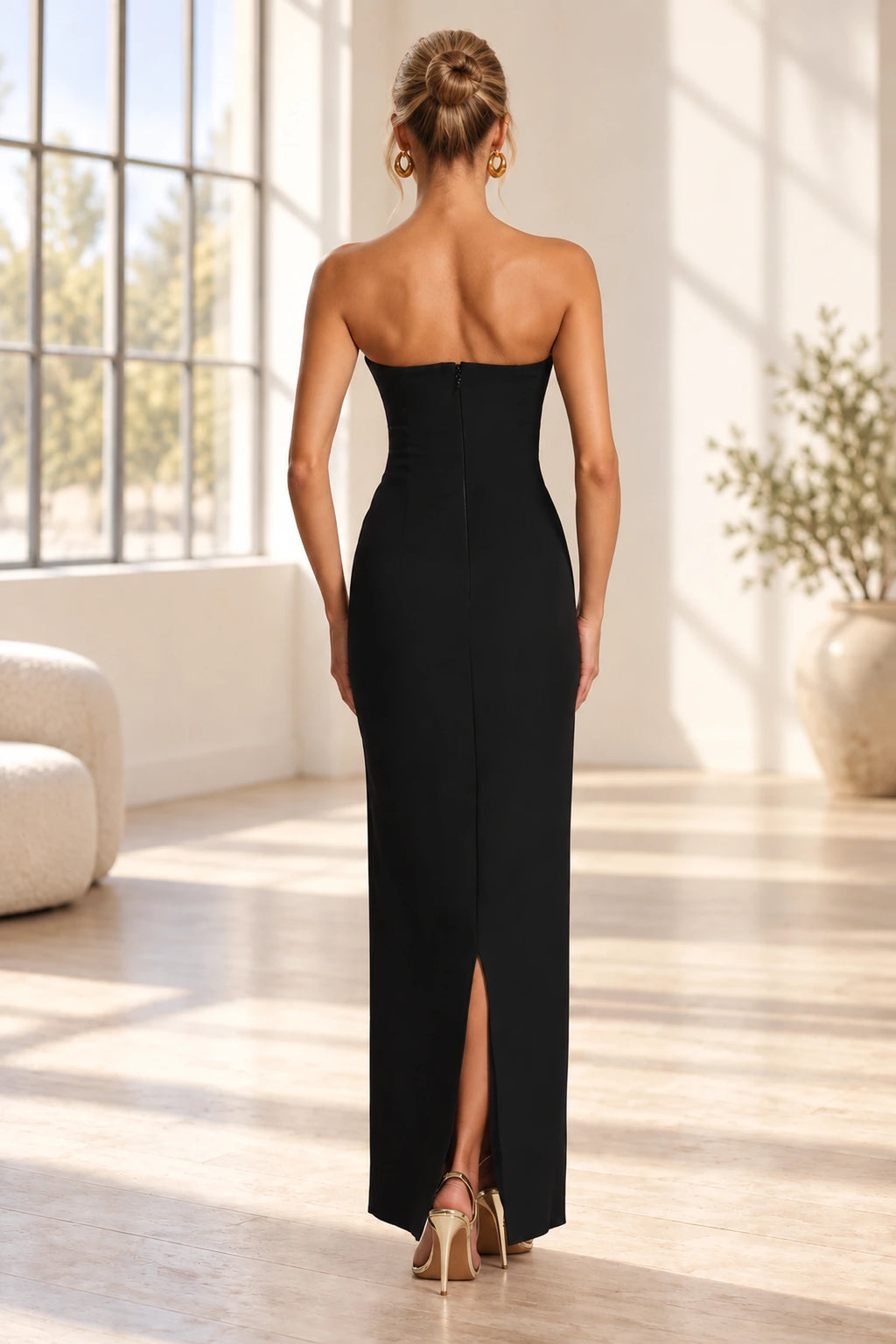Back view of black strapless floor length bridesmaid dress with zipper and back slit by Graceprom