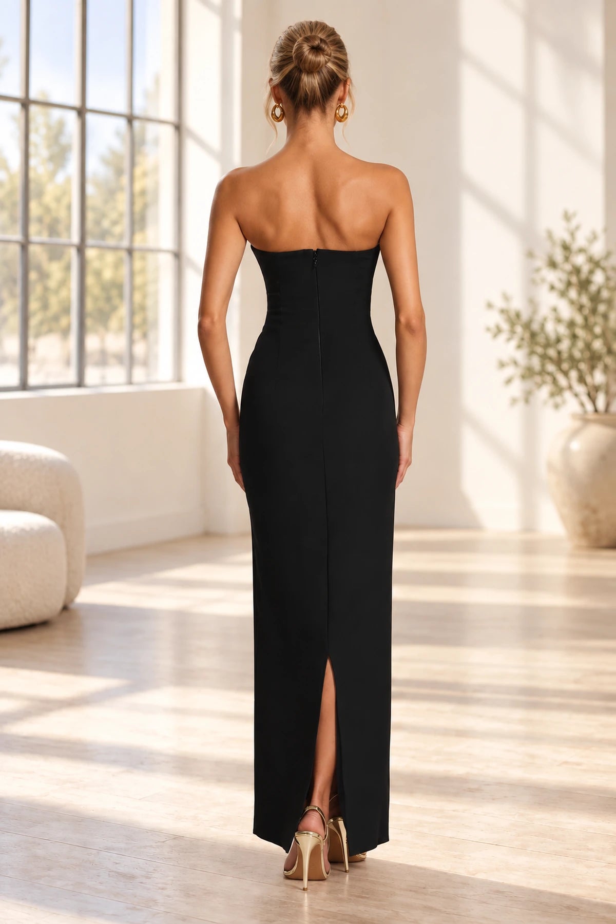 Back view of black strapless floor length bridesmaid dress with zipper and back slit by Graceprom