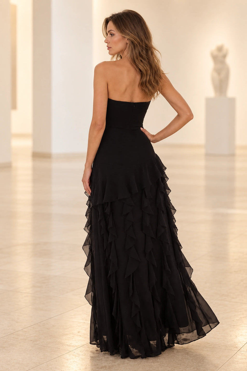 Black floor length prom dress with strapless back and cascading layered ruffle details