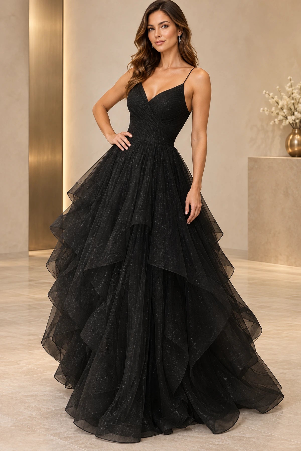 Black ball gown prom dress featuring a V-neckline, spaghetti straps, ruched crossover bodice, and cascading glitter tulle ruffle skirt by Graceprom.