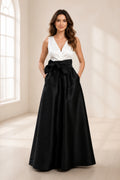 Black and white wedding guest dress with V-neck sleeveless bodice, oversized waist bow and floor-length A-line skirt