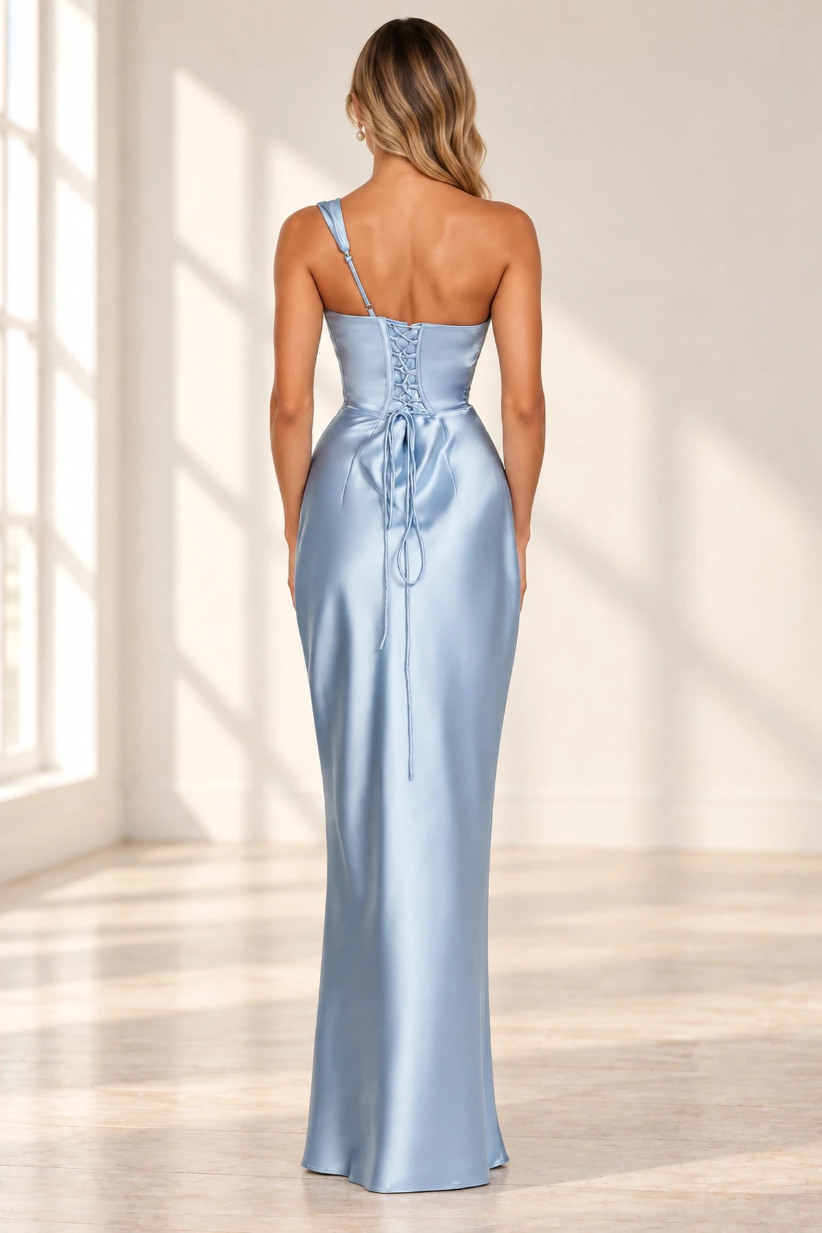 Corset lace up back detail of blue satin formal wedding guest gown