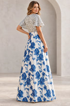 Back view of blue floral Mother of the Bride Dress with silver textured bodice and full floor-length skirt