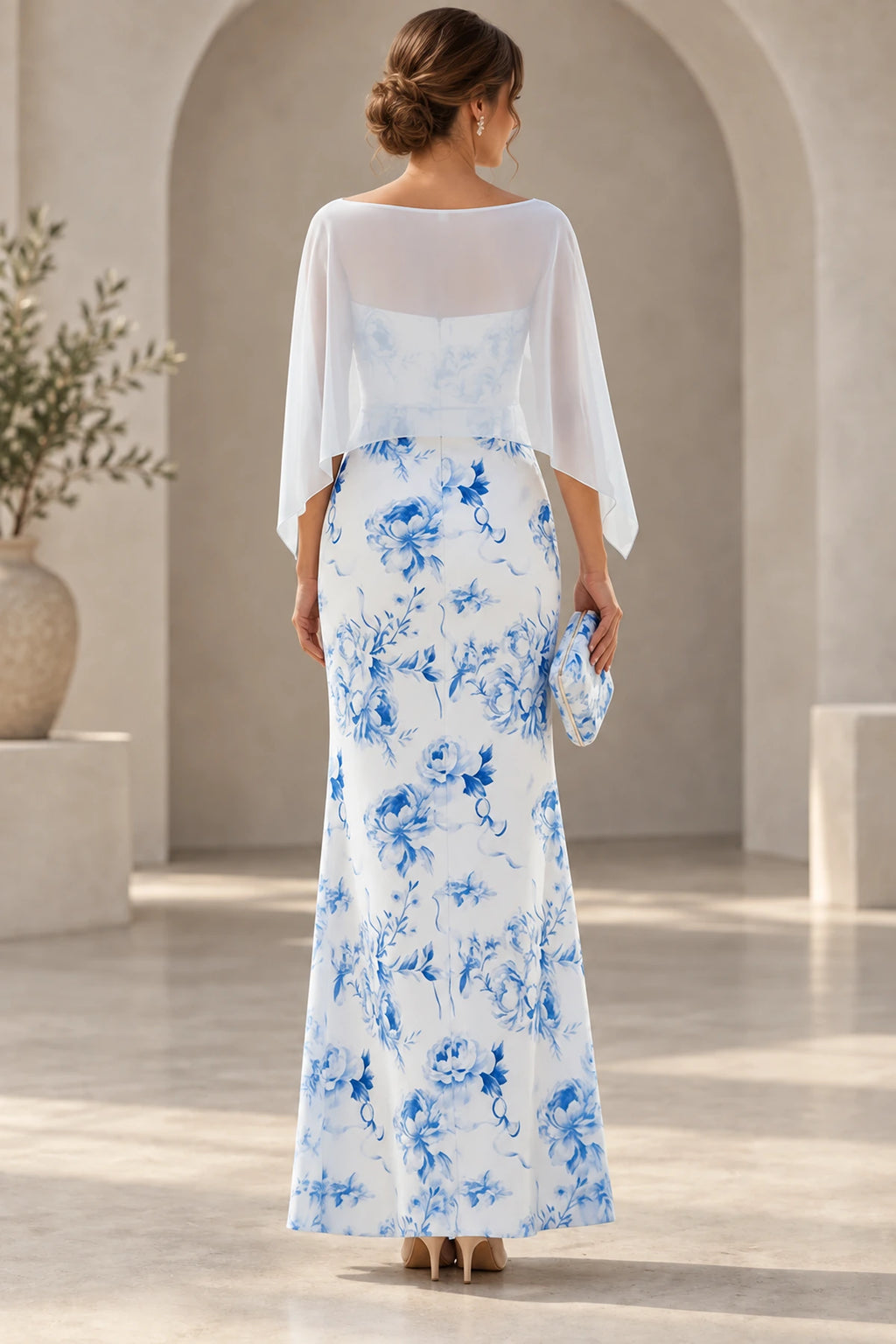 Back view of blue floral Mother of the Bride Dress with sheer cape overlay and floor-length sheath skirt