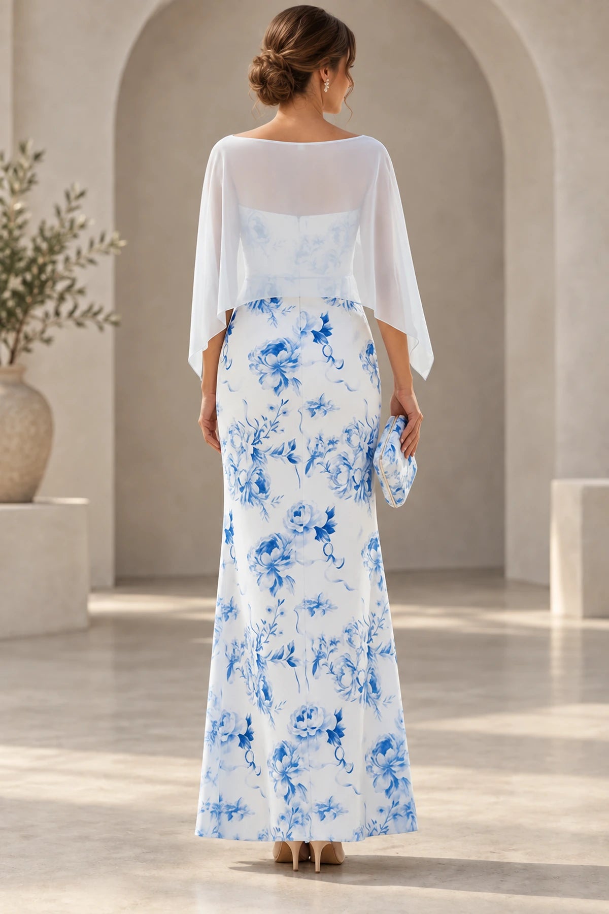 Back view of blue floral Mother of the Bride Dress with sheer cape overlay and floor-length sheath skirt