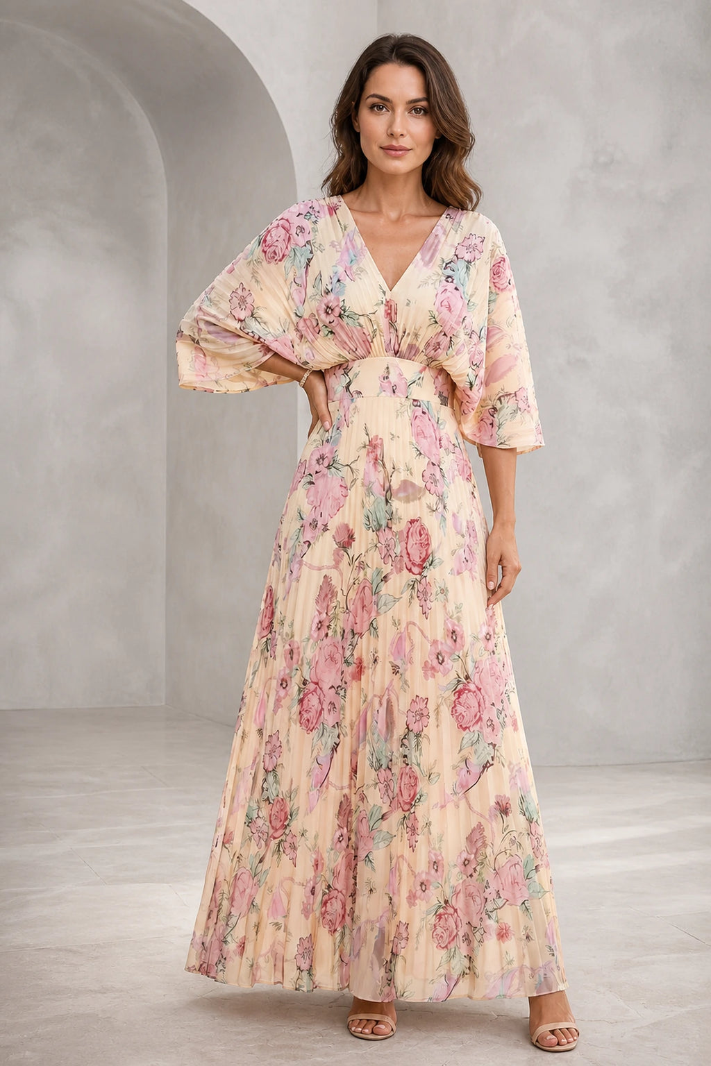 Blush floral mother of the bride dress with V-neckline, flutter sleeves, defined waist and flowing floor-length A-line skirt