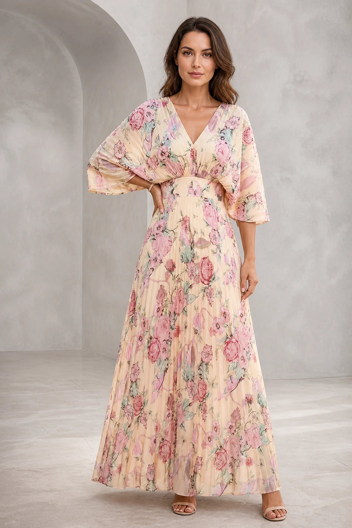 Blush floral mother of the bride dress with V-neckline, flutter sleeves, defined waist and flowing floor-length A-line skirt