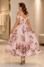 Back view of blush pink floral tea-length wedding guest dress with off-shoulder neckline and zipper back