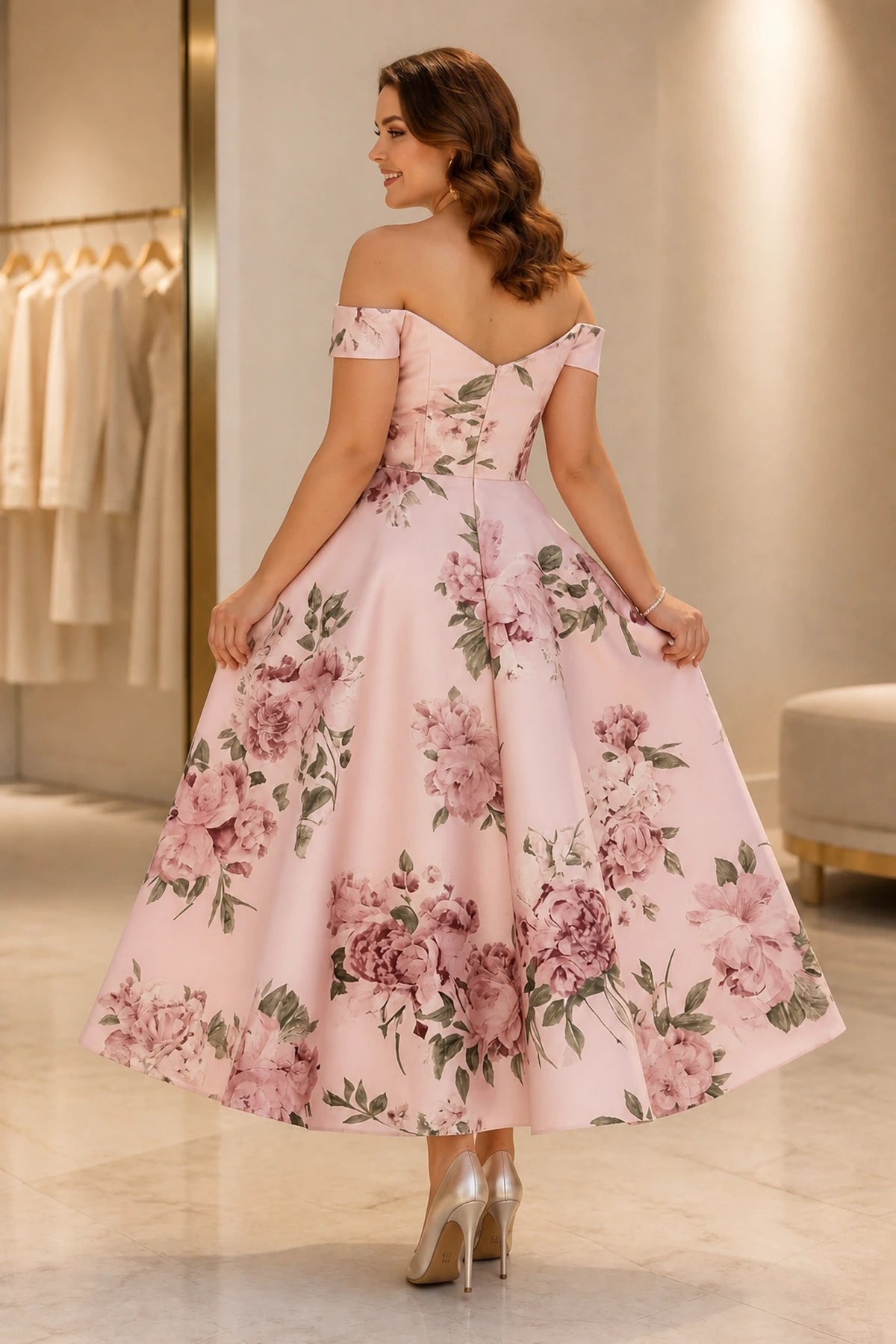 Back view of blush pink floral tea-length wedding guest dress with off-shoulder neckline and zipper back