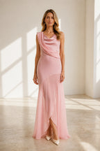 GraceProm blush pink wedding guest dress with cowl neckline draped shoulder detail and floor length skirt