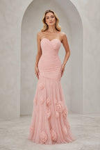 Blush pink strapless sweetheart mermaid wedding guest dress with ruched bodice and floral applique floor-length skirt