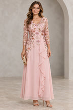 Blush pink Mother of the Bride Dress with floral embroidered V neckline, three quarter illusion sleeves and draped floor length skirt