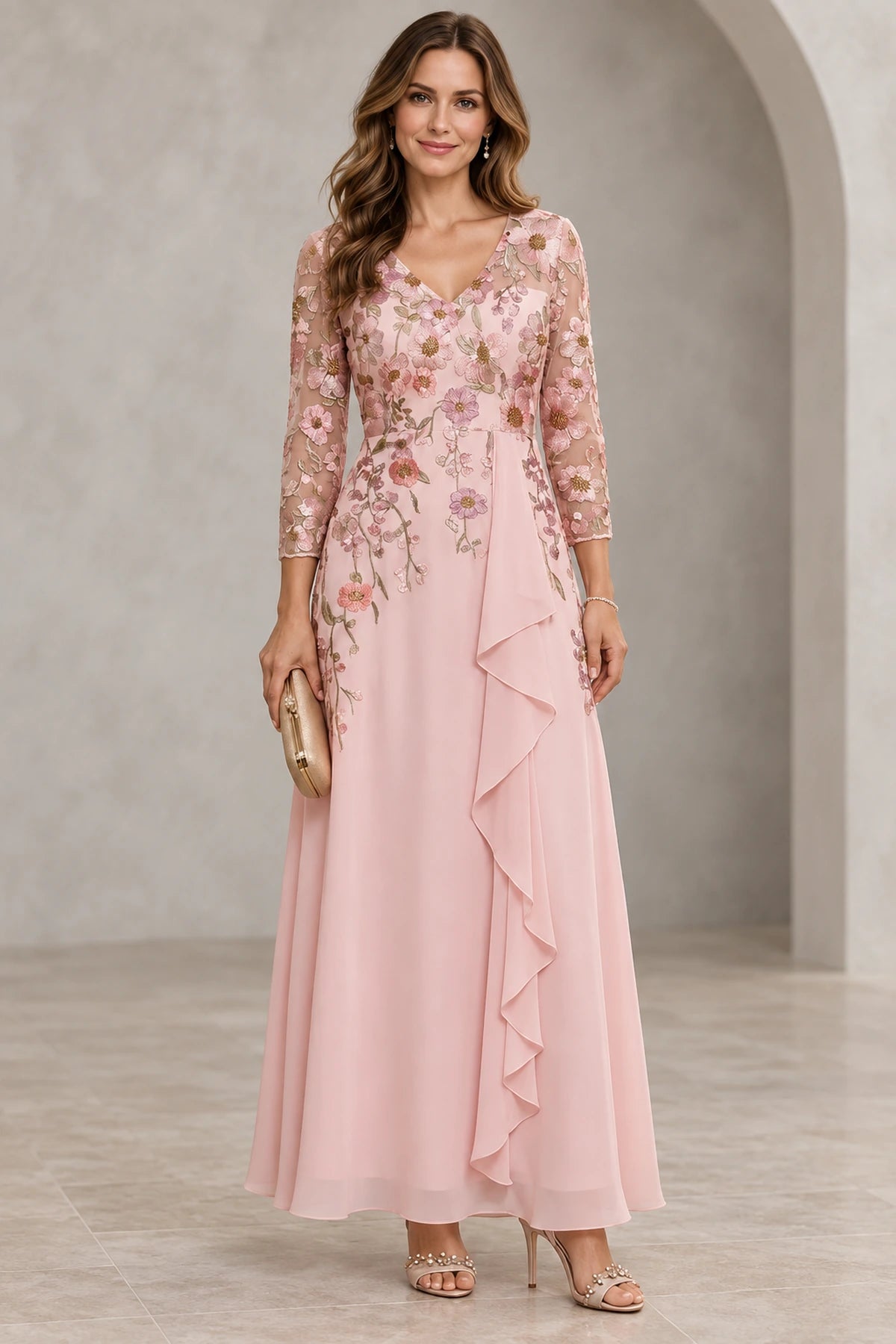 Blush pink Mother of the Bride Dress with floral embroidered V neckline, three quarter illusion sleeves and draped floor length skirt
