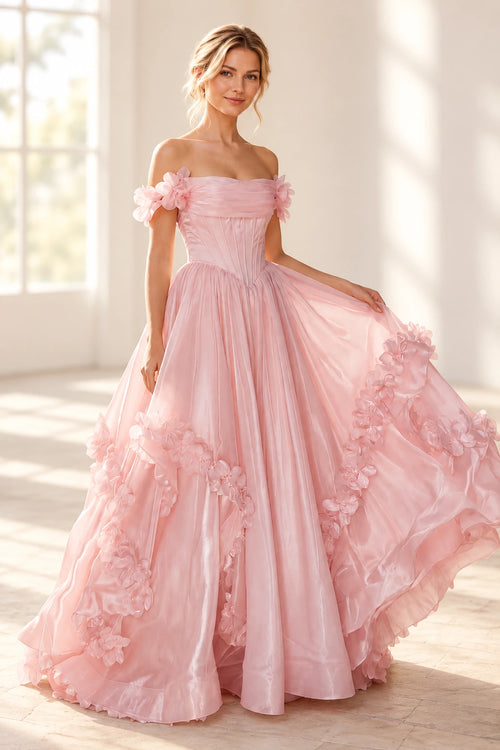 Blush pink A line prom dress with a pleated off shoulder neckline, floral arm details, pointed corset-style waist, and flower-trimmed skirt.