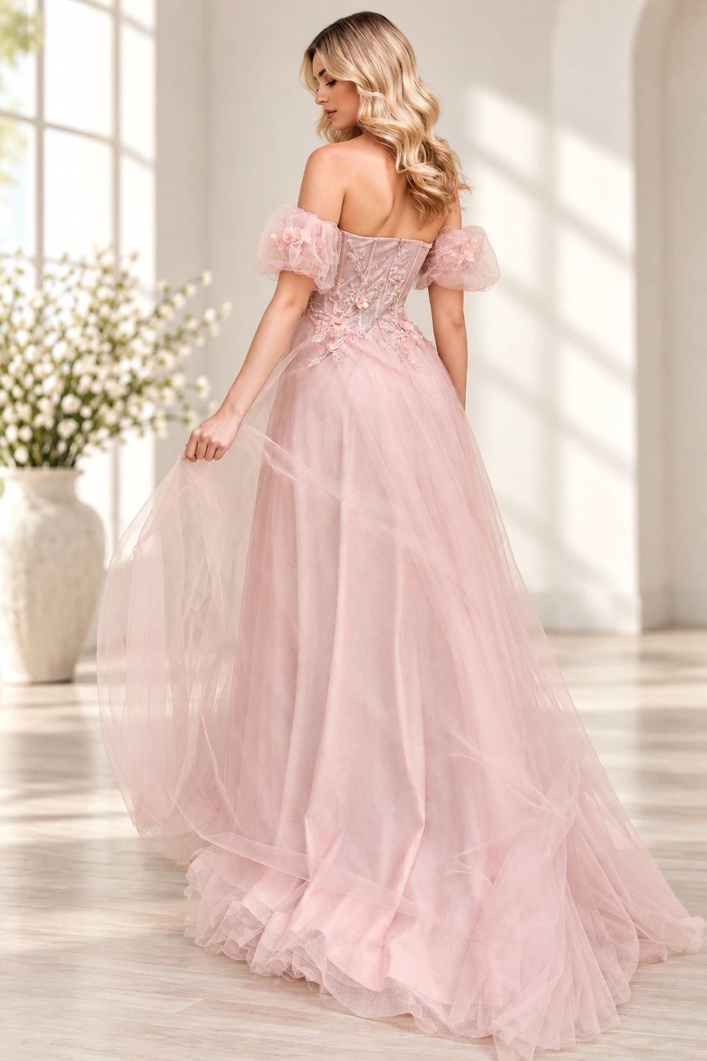 Blush pink tulle prom dress with structured corset back and floral applique details