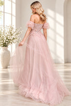 Blush pink tulle prom dress with structured corset back and floral applique details