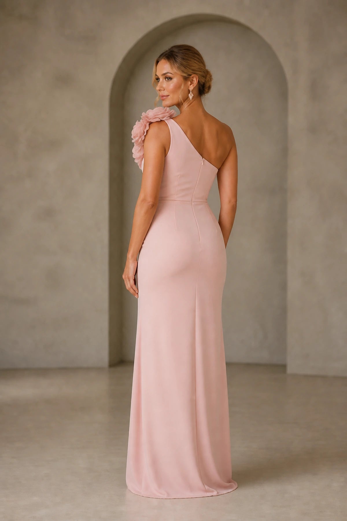 Back view of blush pink fitted prom dress with asymmetric shoulder and zipper closure