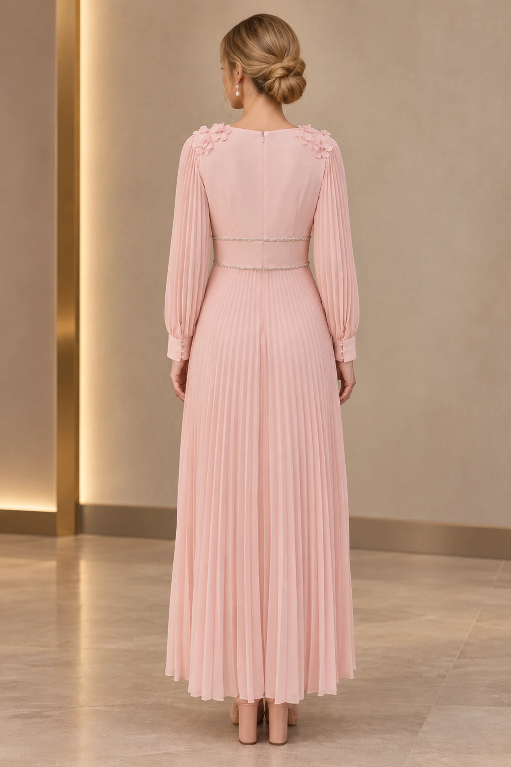 Back view of blush pink Mother of the Bride Dress with closed back, floral shoulder details and ankle-length pleated skirt
