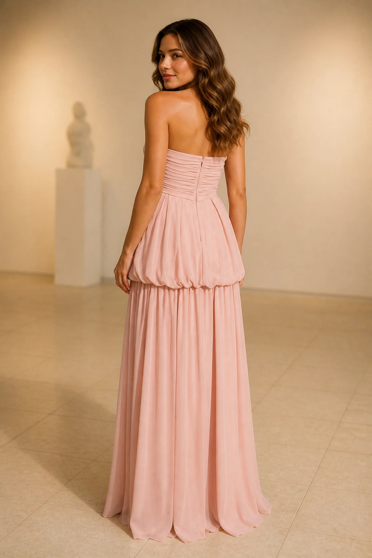 Blush pink strapless ruched A-line long bridesmaid dress with pleated skirt