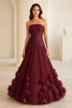 Burgundy strapless floor-length wedding guest ball gown with pleated skirt and 3D floral appliques