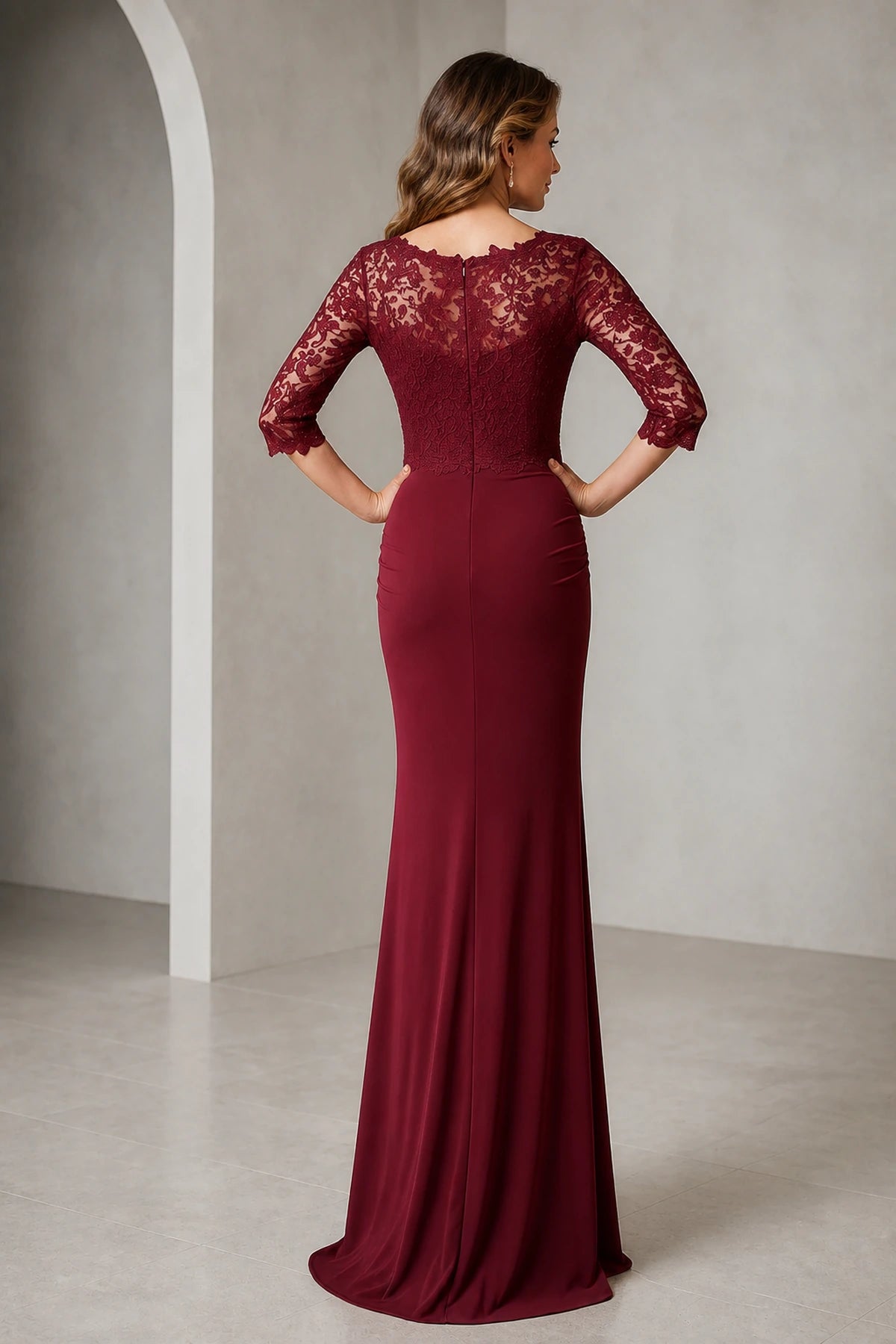 Back view of Vedress burgundy mother of the bride dress with sheer lace back, three quarter sleeves, center back zipper and long mermaid silhouette