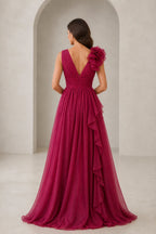 Burgundy bridesmaid dress with V-back, shoulder ruffle, and flowing floor-length skirt