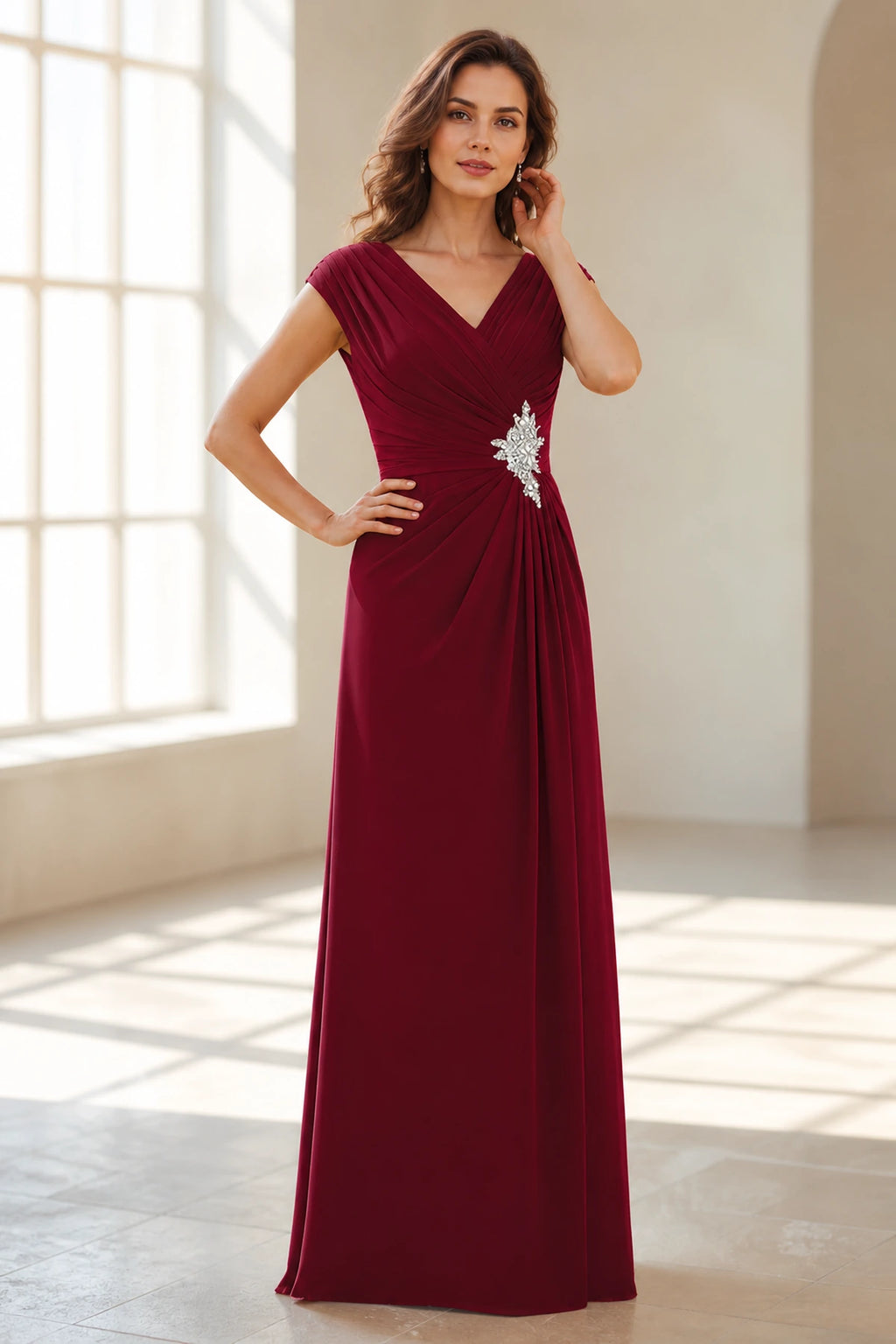 Front view of Vedress burgundy wedding guest dress with V neckline, cap sleeves, ruched waist, crystal embellishment and floor length skirt
