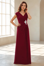 Front view of Vedress burgundy wedding guest dress with V neckline, cap sleeves, ruched waist, crystal embellishment and floor length skirt