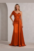 Front view of Vedress burnt orange wedding guest dress with sweetheart neckline, one shoulder drape, ruched waist and floor length skirt