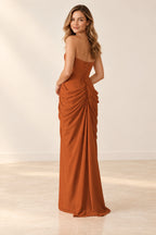 Burnt orange bridesmaid dress back view featuring crisscross lacing, a waist tie, and gathered skirt draping.