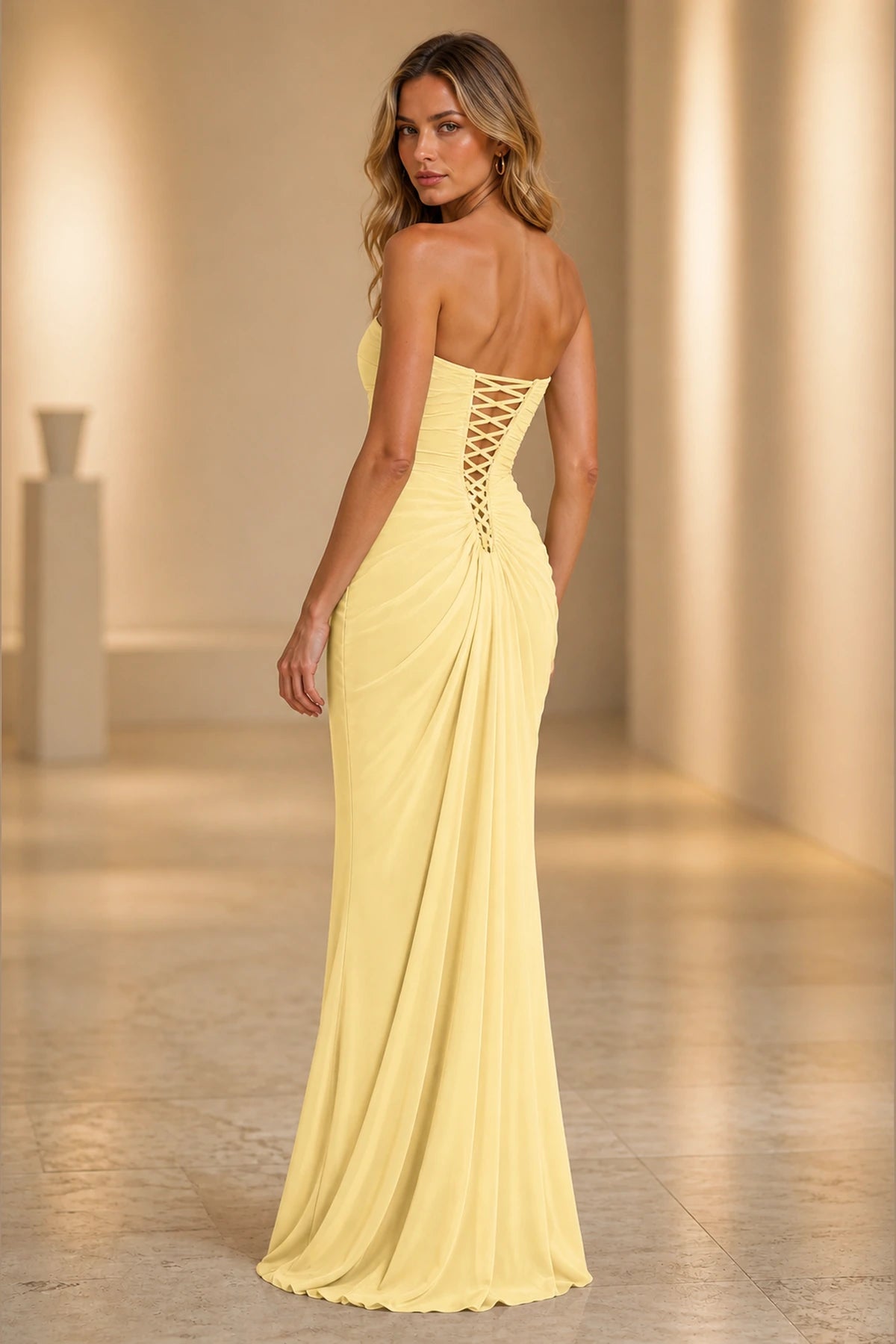 Butter yellow strapless bridesmaid dress with lace-up back and draped floor-length skirt