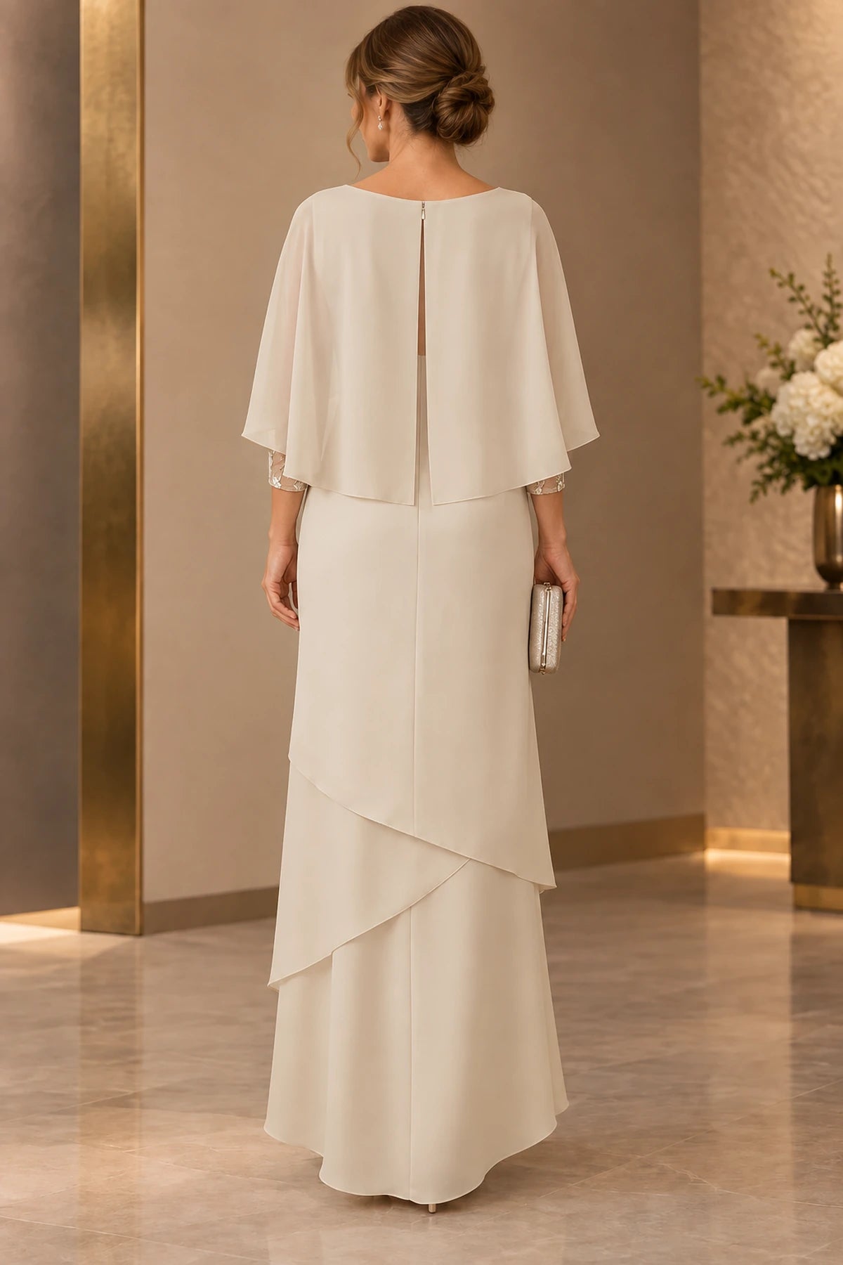 Back view of champagne Mother of the Bride Dress with cape overlay, keyhole back and layered floor-length chiffon skirt