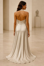 Back view of GraceProm champagne gold open-back halter wedding guest dress