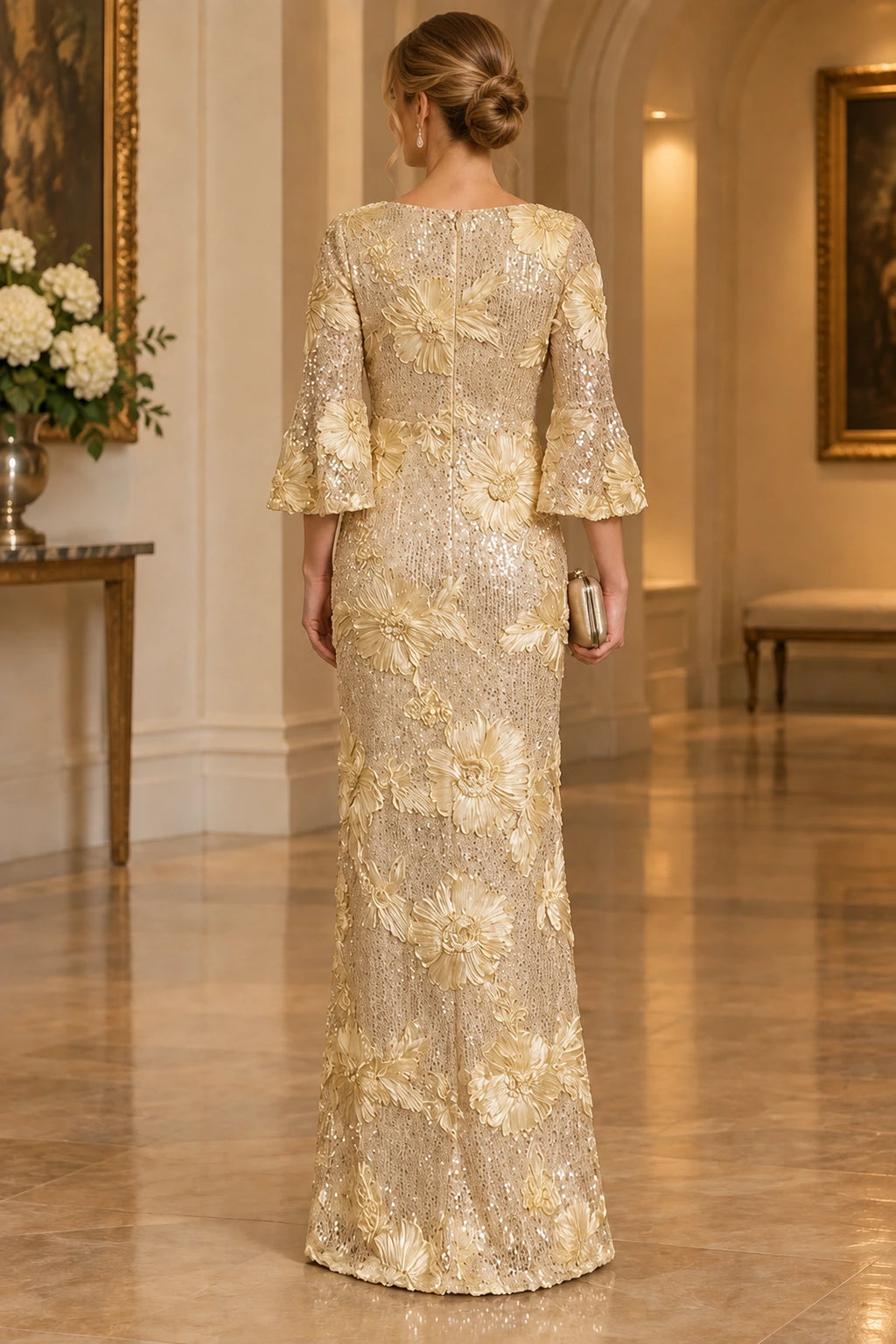 Back view of champagne gold Mother of the Bride Dress with bell sleeves, sequin floral detailing and floor-length sheath silhouette