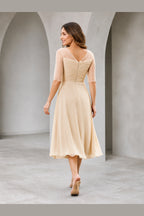 Vedress champagne mother of the bride dress with sheer elbow sleeves V-back zipper closure ruched bodice and tea-length A-line skirt back view