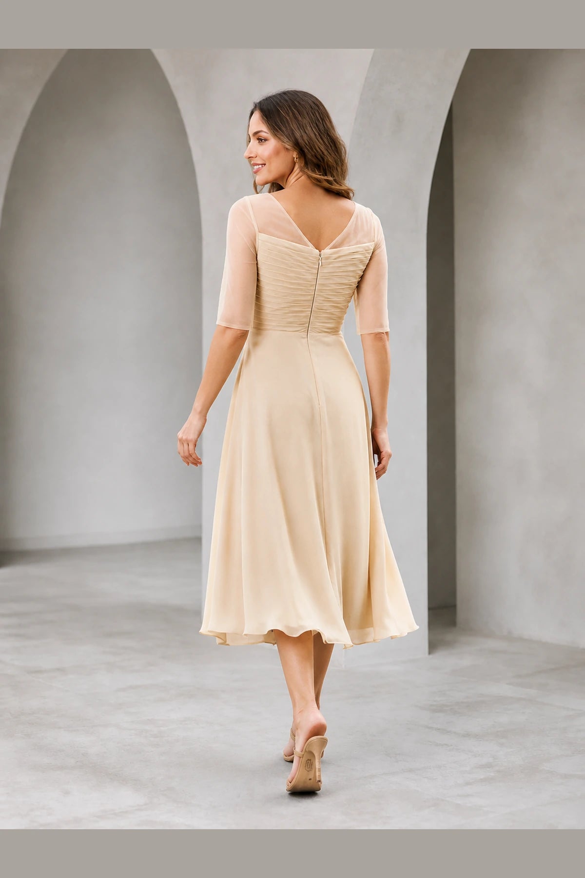 Vedress champagne mother of the bride dress with sheer elbow sleeves V-back zipper closure ruched bodice and tea-length A-line skirt back view