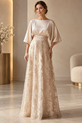 Champagne Mother of the Bride Dress with bateau neckline, cape sleeves, ruched waist and floral lace skirt