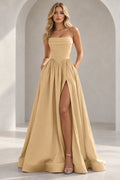 Champagne strapless A line prom dress with a pleated foldover neckline, pointed corset-style waist, gathered skirt, and thigh-high slit.