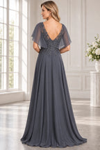 Back view of charcoal gray Mother of the Bride Dress with deep V-back, flutter sleeves and flowing sweep-train skirt