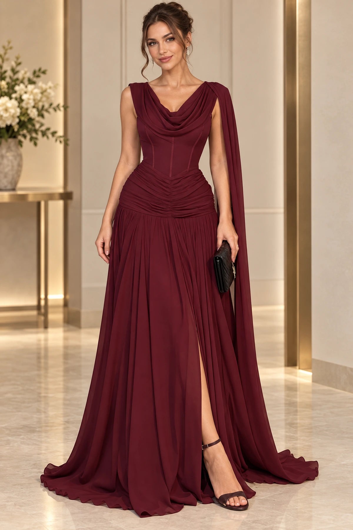 Graceprom burgundy chiffon A-line prom dress with a cowl neckline, corset-style bodice, ruched hips, front slit and long shoulder cape.