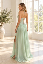 Back view of a mint green Graceprom chiffon prom dress with halter neck ties, a sheer floral lace bodice, crisscross back lacing and flowing skirt.